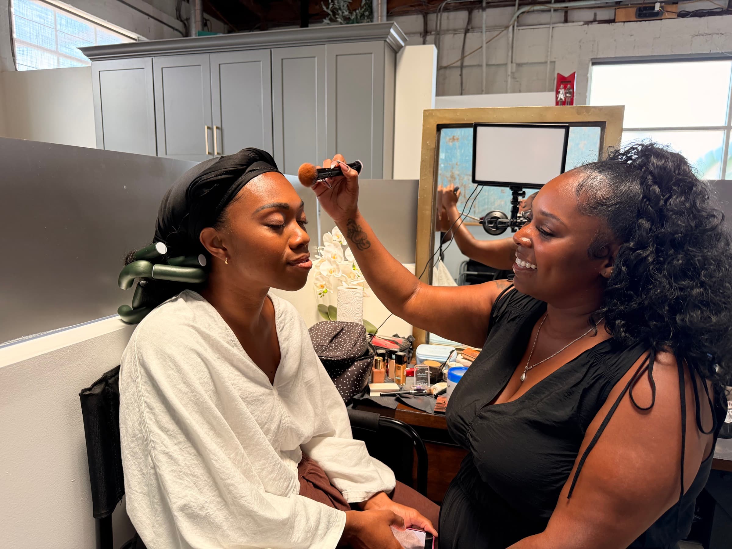 An actor in hair and makeup before a take