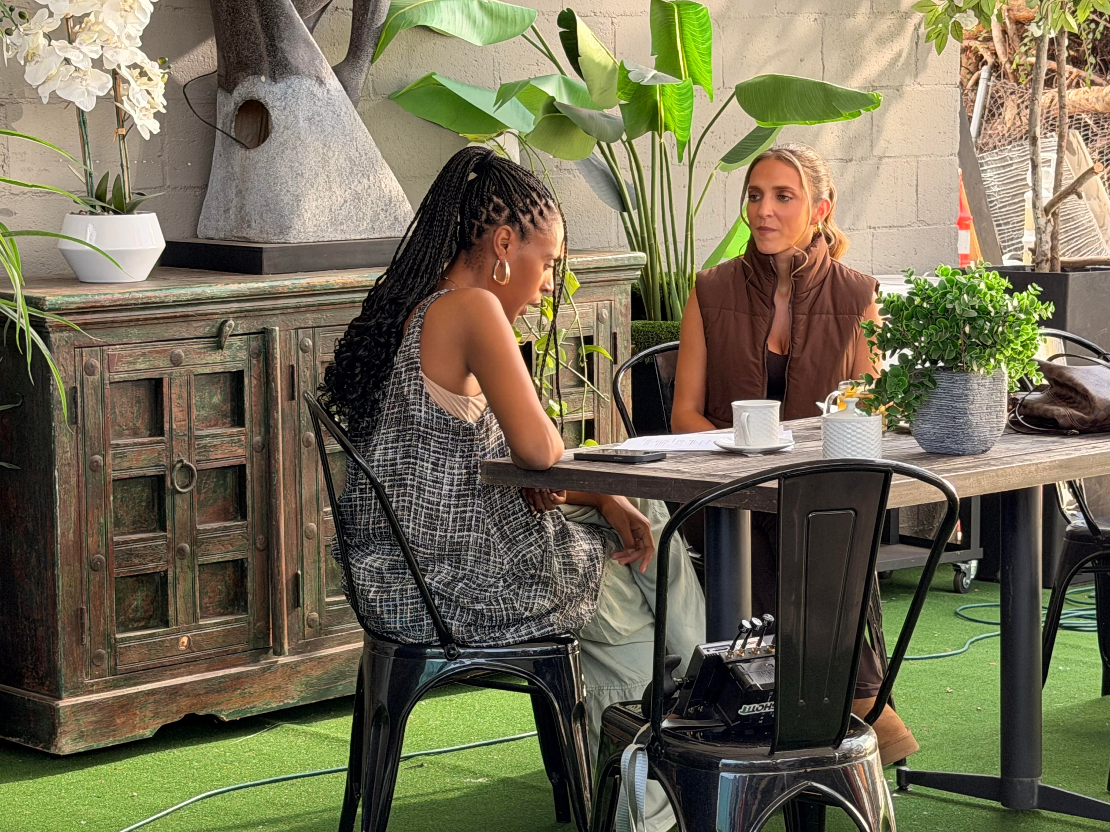 The patio set, actors in scene at the table