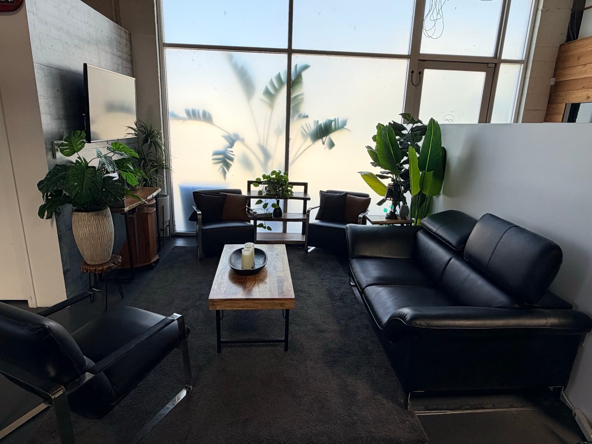 The waiting room set with leather sofas, armchairs, and a coffee table