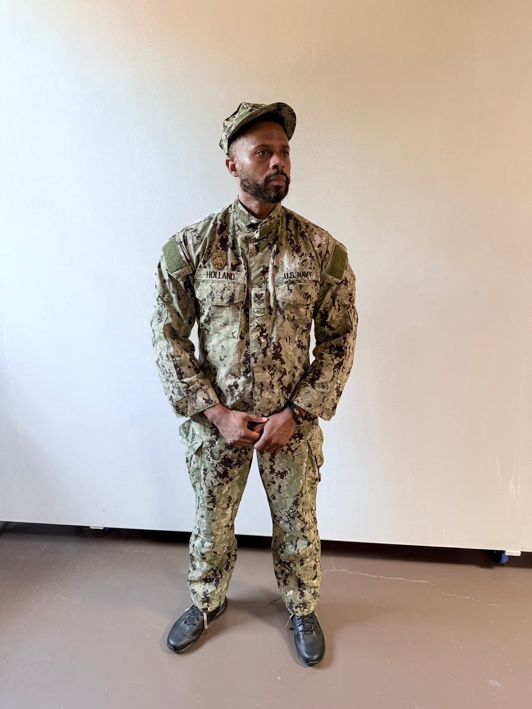 An actor in a US Navy working uniform from the studio wardrobe
